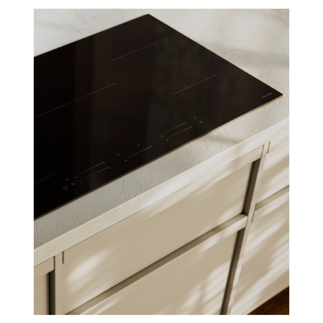 Black induction cooktop built into a light-colored kitchen countertop