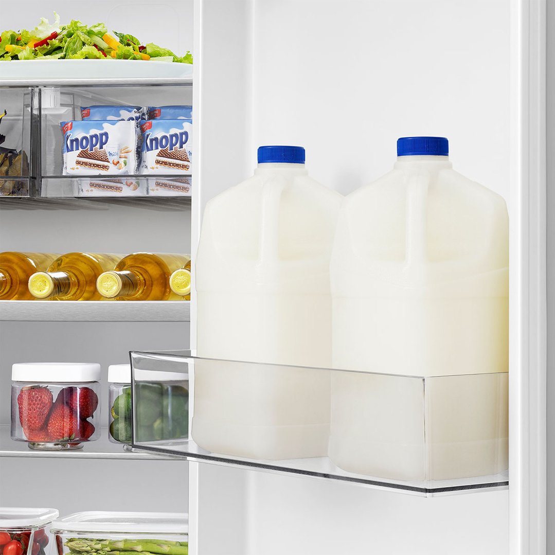 Interior of a fridge with food items on shelves and in drawers