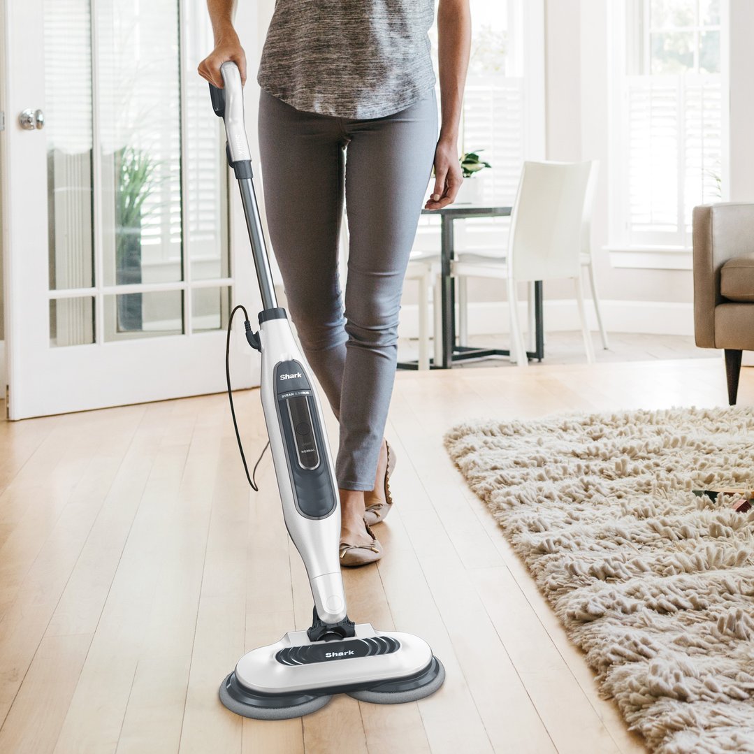 Woman using a Shark Steam and Scrub Mop on a wooden floor