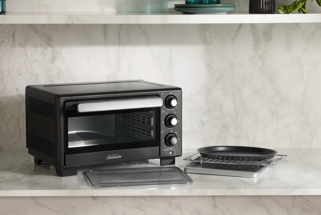 Sunbeam NutriCrisp 17L Air Fryer Oven on a marble countertop with accessories