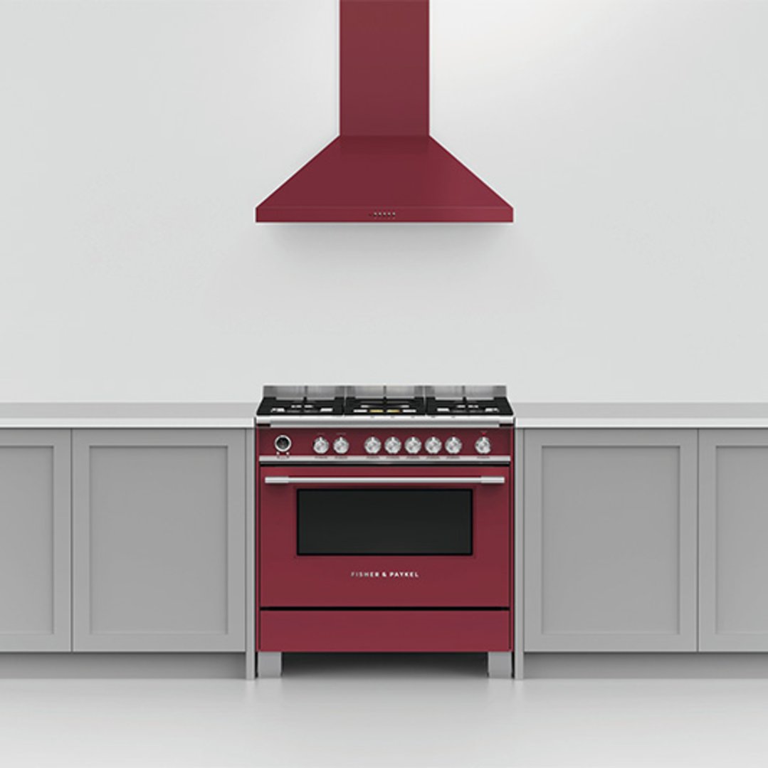 Red rangehood and matching range cooker in a modern kitchen setting
