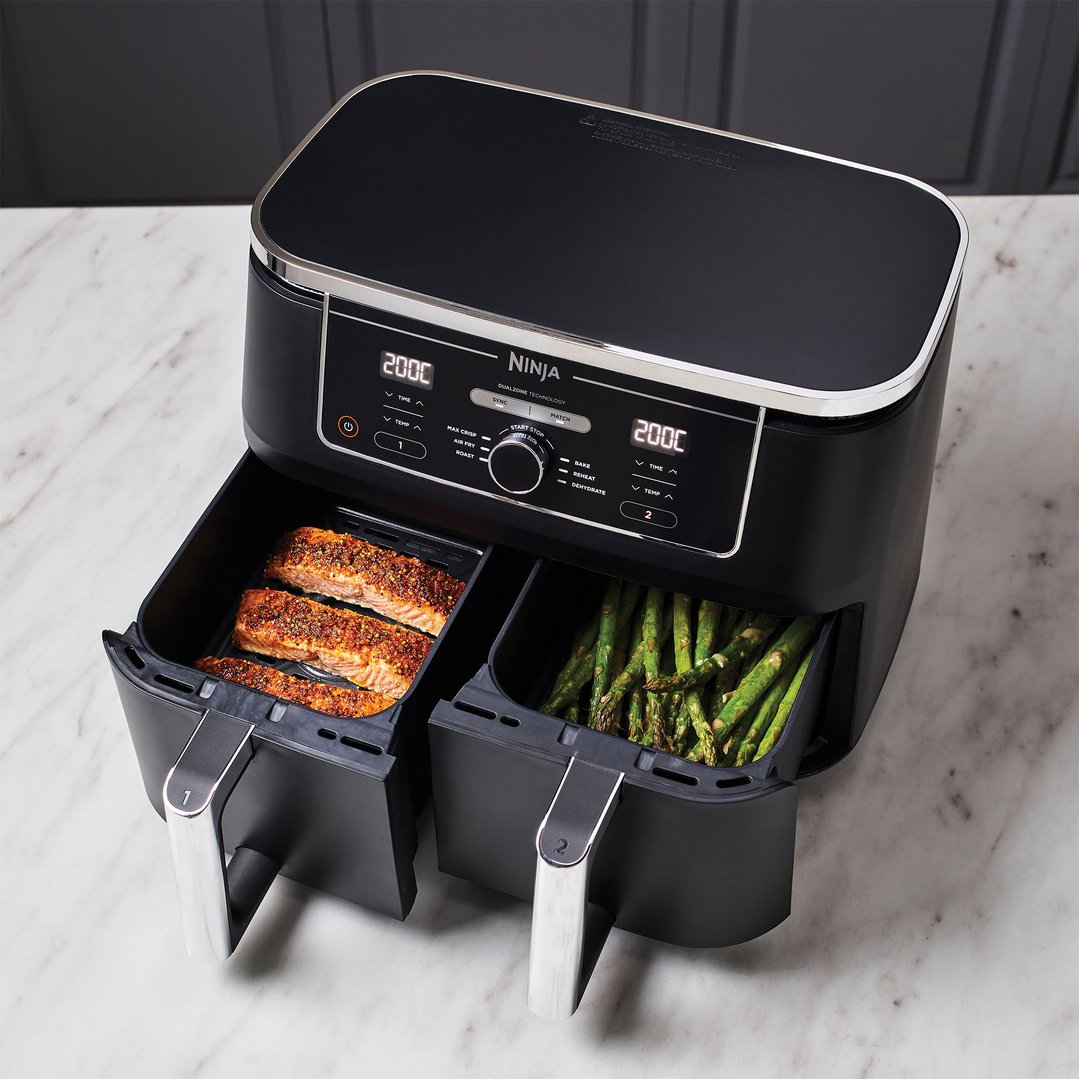 Black Ninja Foodi MAX Dual Zone Air Fryer cooking salmon and asparagus