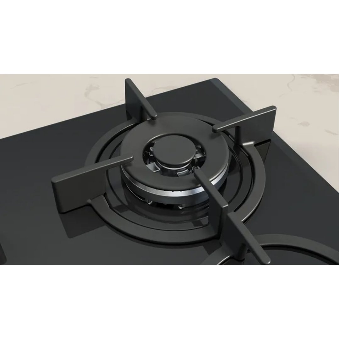 Close-up of a black gas cooktop with a wok burner on a light countertop