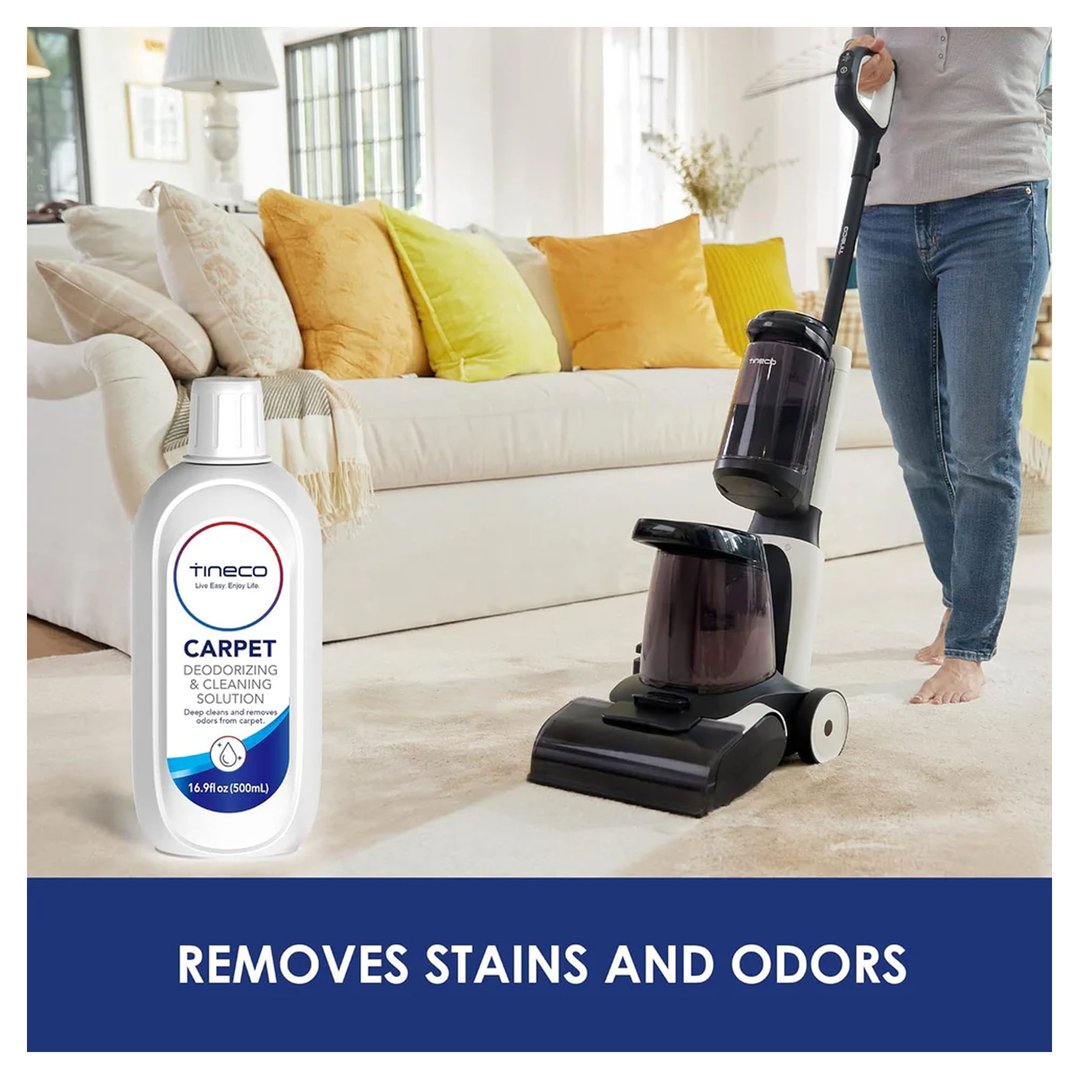 Carpet cleaning solution bottle and carpet cleaner in use on a carpet