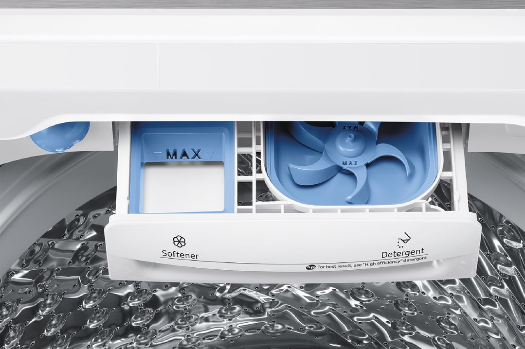 Close-up of a washing machine's detergent and softener dispenser drawer