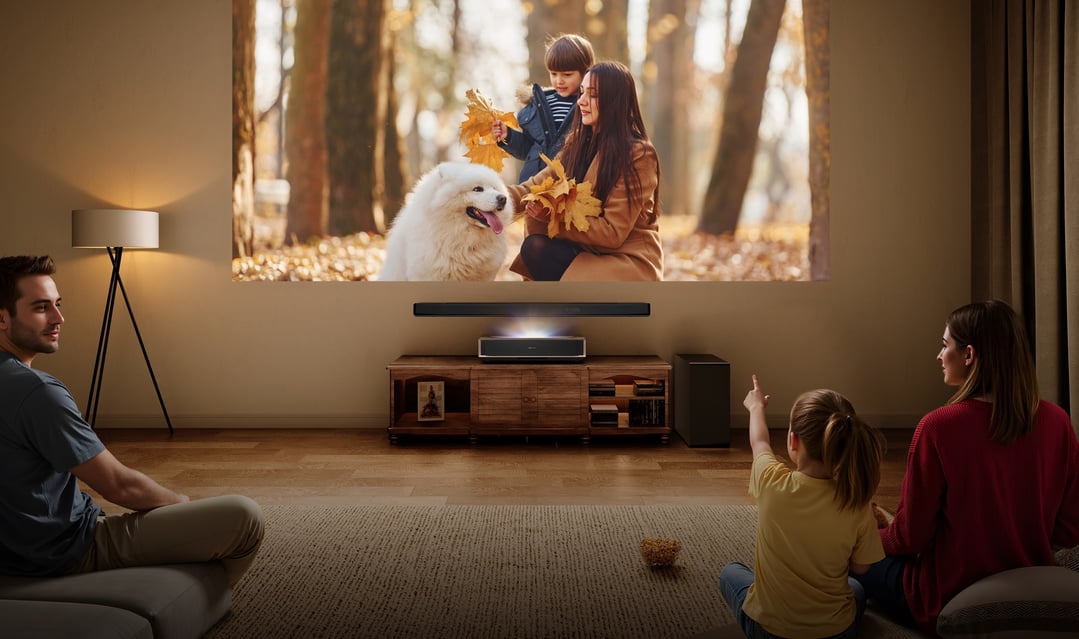 Family watching a movie projected by a projector in a living room