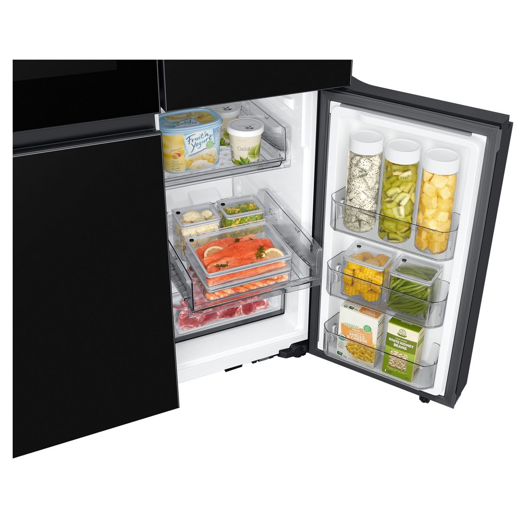 Open black French door refrigerator showing various food items inside