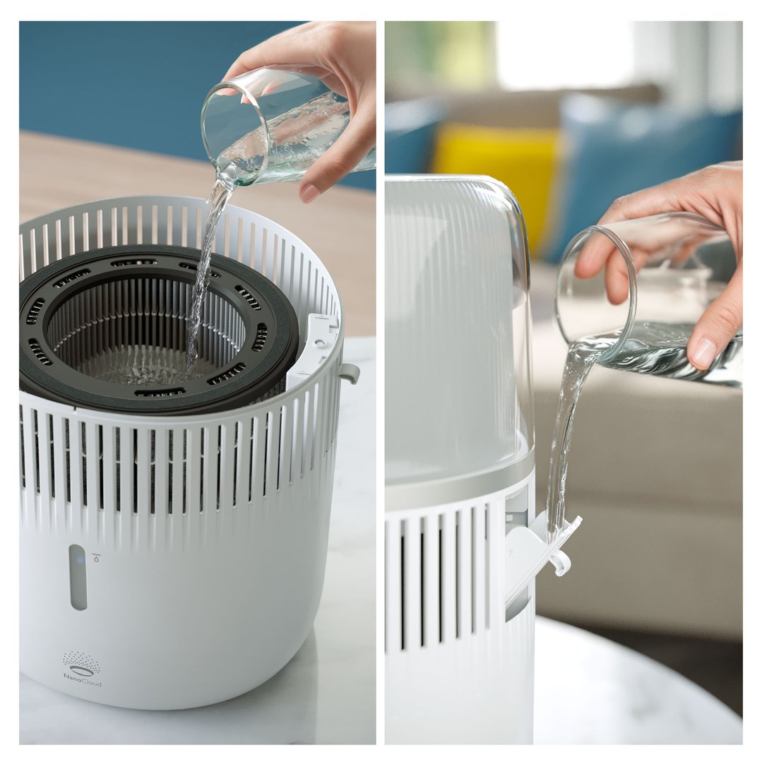 Hands pouring water into the Philips Series 5000 Evaporative Humidifier