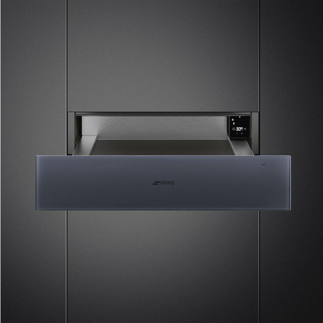 Smeg warming drawer with touch controls, partially open, built into dark cabinetry