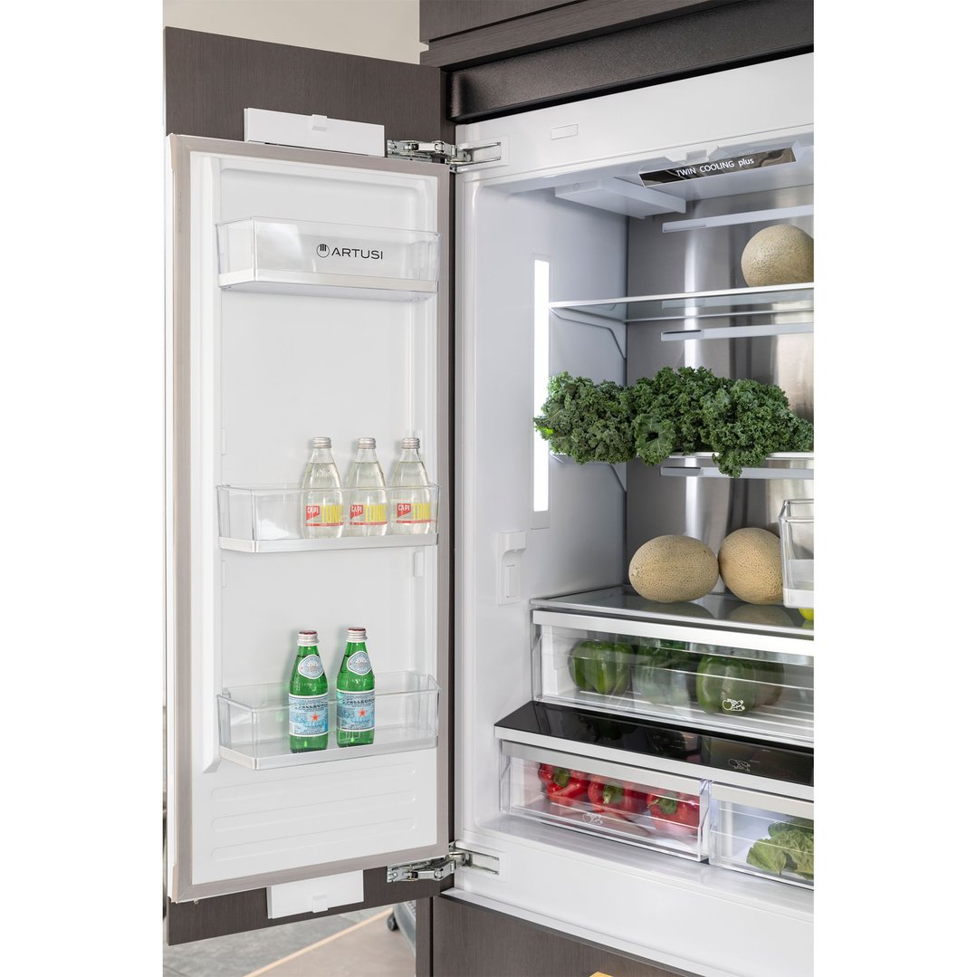 Open integrated French door fridge showing interior with food and drinks