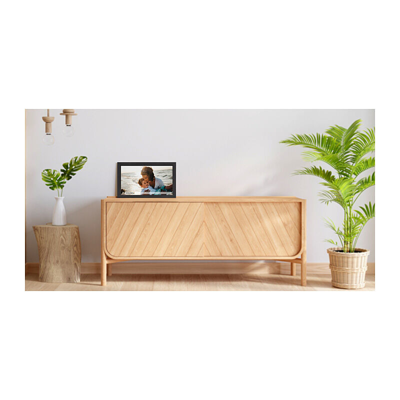 NIVO digital photo frame displaying a photo, on a wooden cabinet