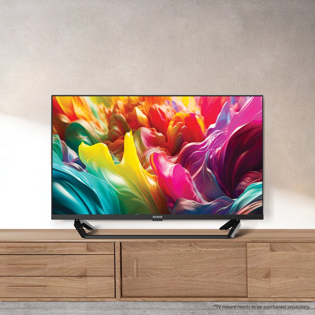 CHIQ TV on a wooden entertainment unit against a light wall