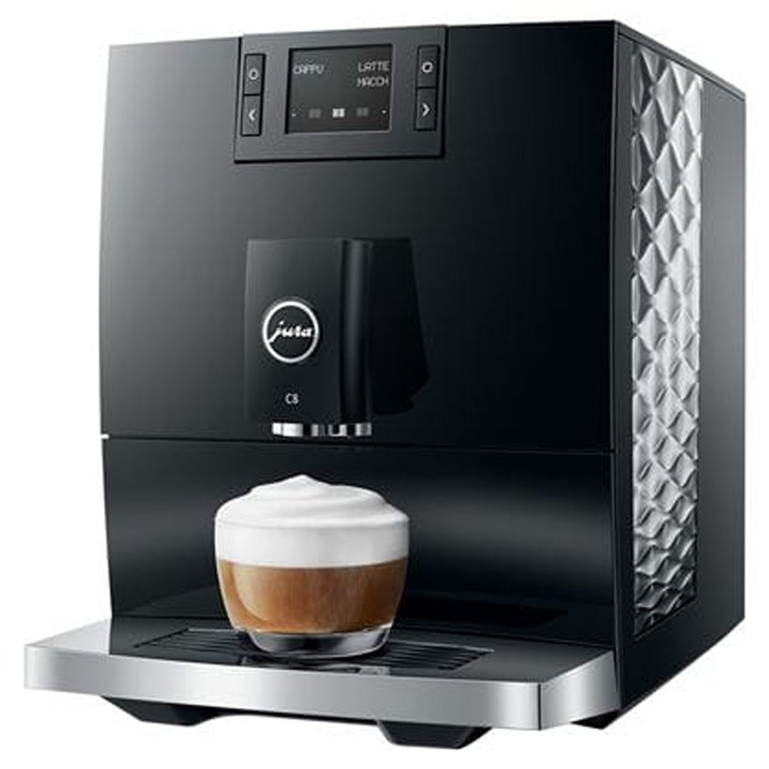 Black JURA C8 coffee machine dispensing a latte into a glass