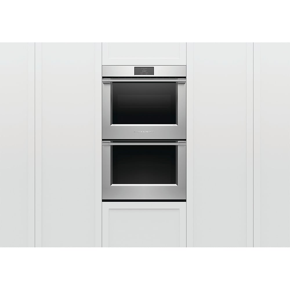 Stainless steel double oven built into white kitchen cabinetry
