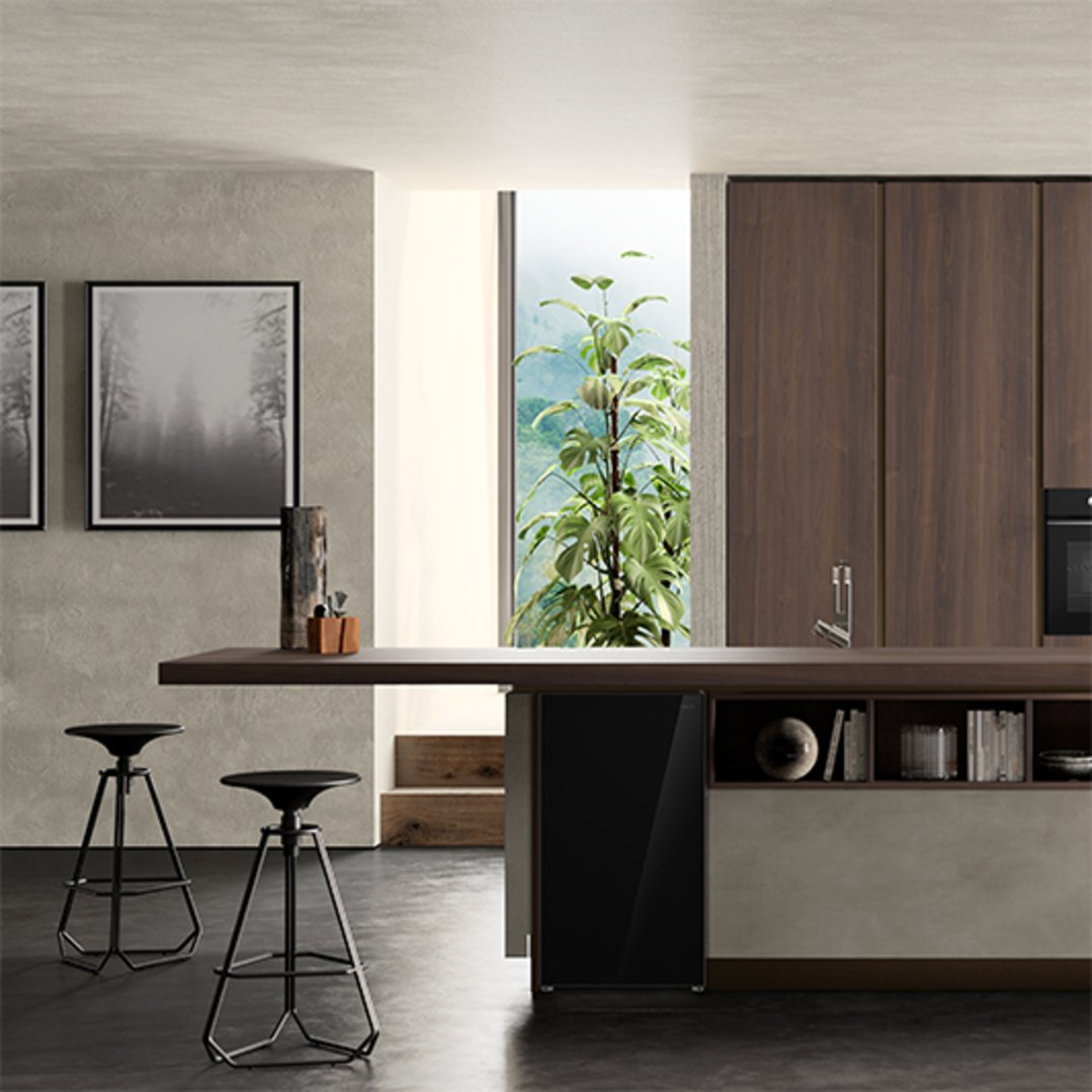 Black bar fridge integrated into a kitchen island with stools and decor