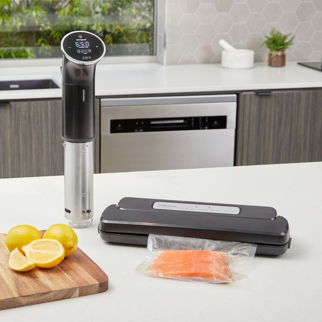 Sous vide immersion cooker and vacuum sealer on a kitchen counter