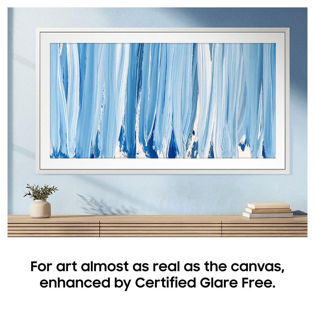 The Frame TV displaying blue abstract art, mounted on a light blue wall