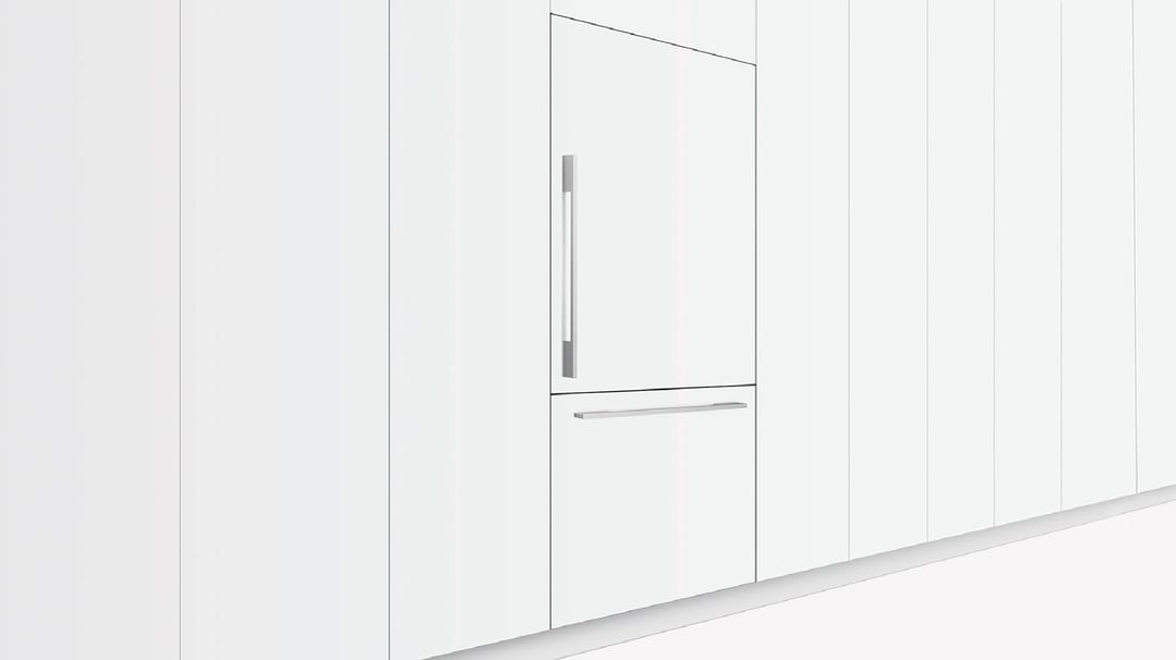 Integrated refrigerator freezer with two doors and handles in a white kitchen