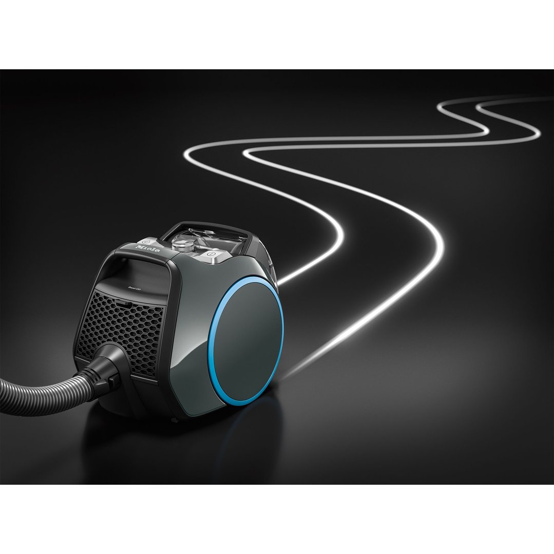 Miele Boost CX1 Bagless Vacuum Cleaner in graphite grey on a dark surface