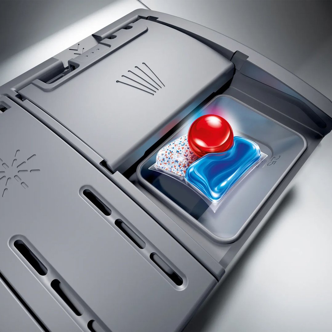 Close up of dishwasher detergent dispenser with three different detergent types