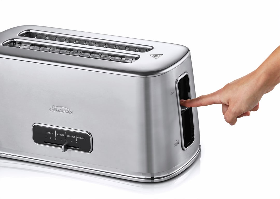 Hand pressing the lever on a stainless steel Sunbeam 4-slice long slot toaster