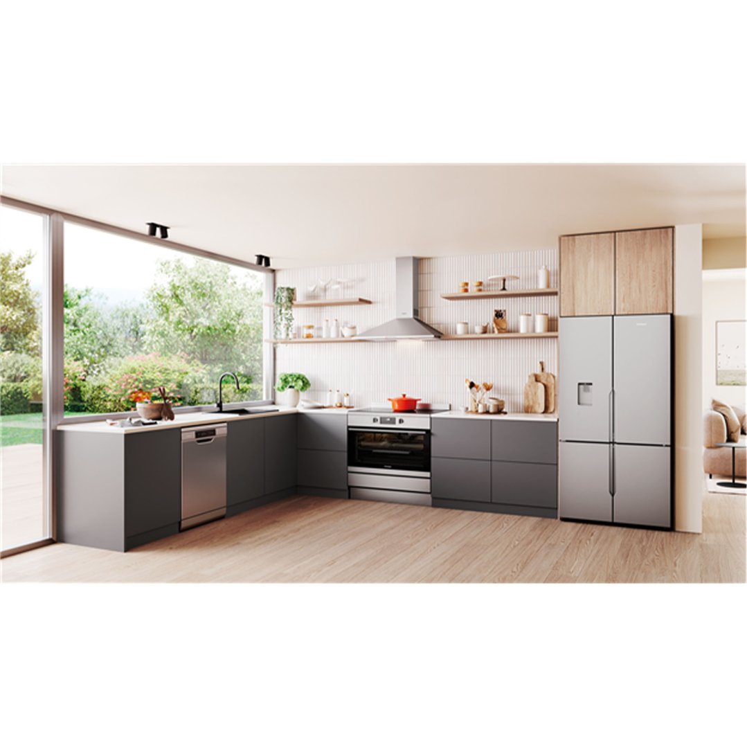 Canopy rangehood in a modern kitchen with grey cabinets and large window