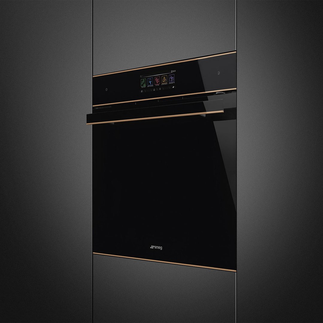 Black glass Smeg OmniChef oven with copper trim built into dark cabinetry
