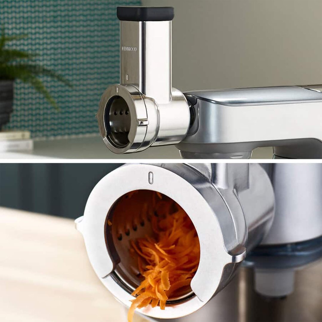 Close-up of a Kenwood rotary slicer/grater shredding carrots in a kitchen setting