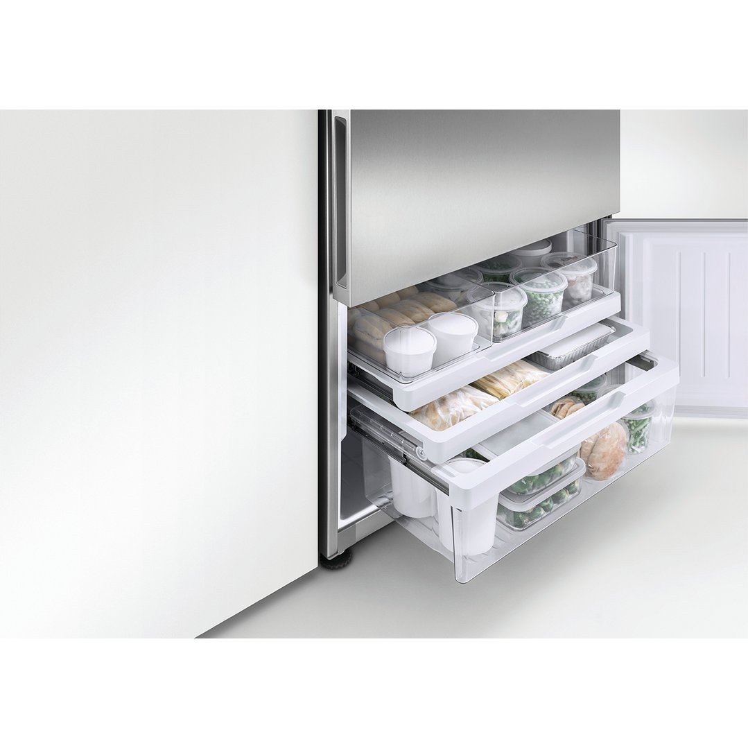 Open freezer drawers of a stainless steel refrigerator freezer filled with food