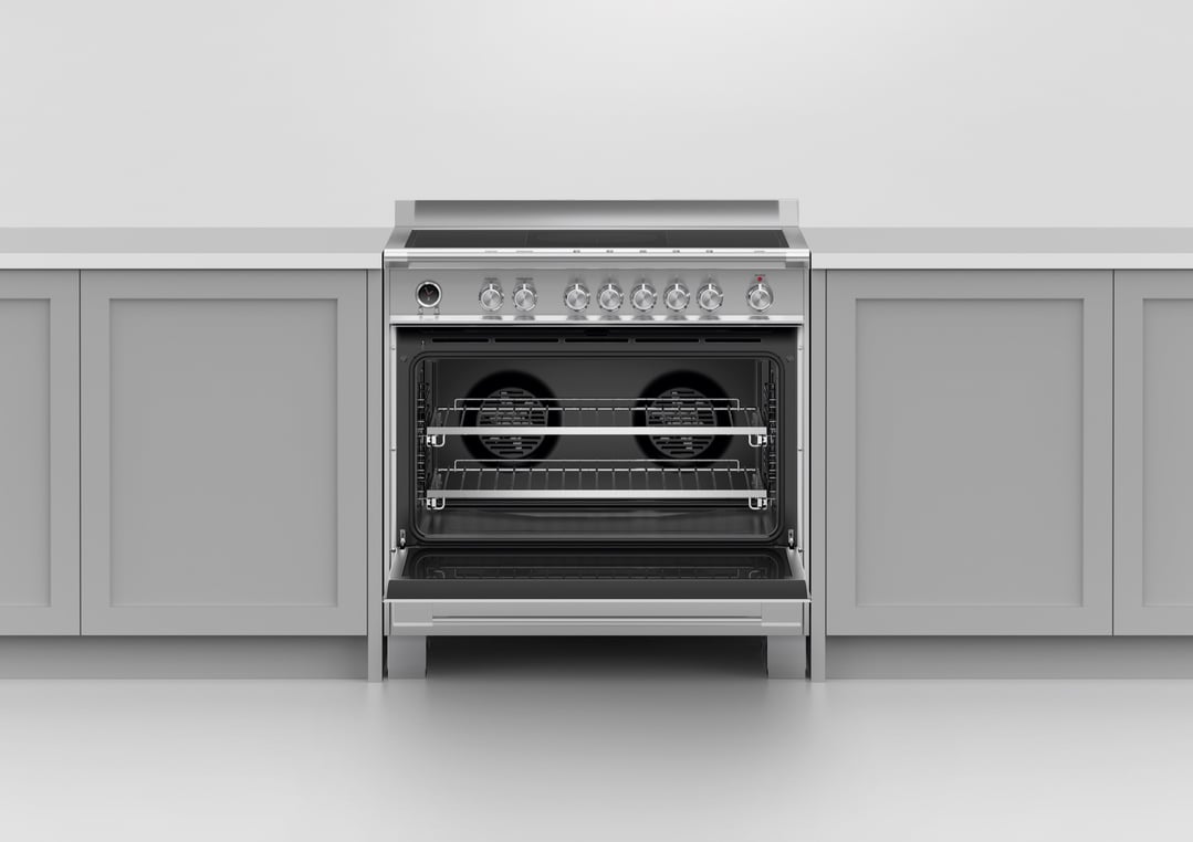A stainless steel freestanding cooker with an open oven door in a kitchen setting