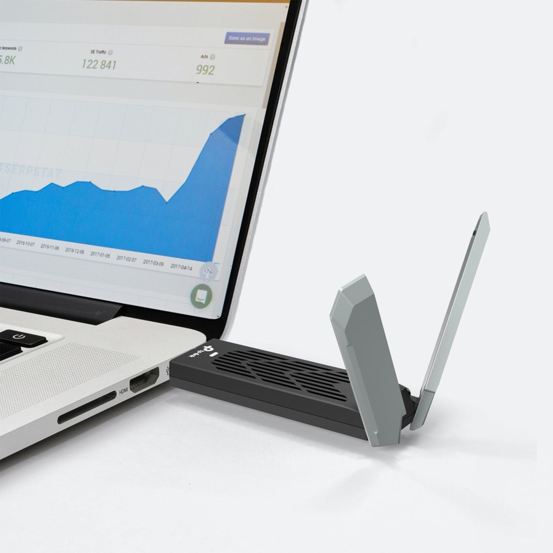 TP-LINK Wi-Fi 7 High Gain Wireless USB Adapter plugged into a laptop