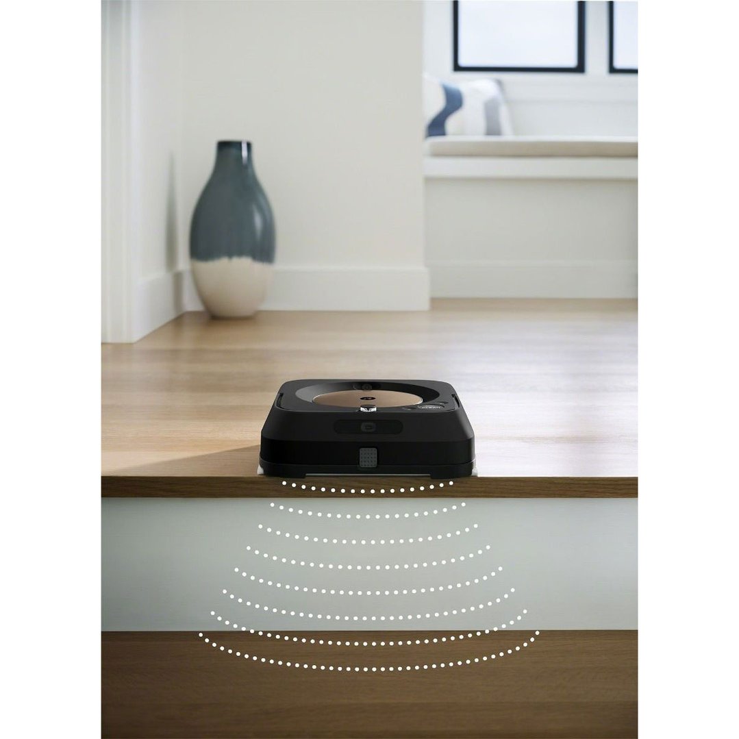 Black robot mop on a wooden floor near a step with sensor waves
