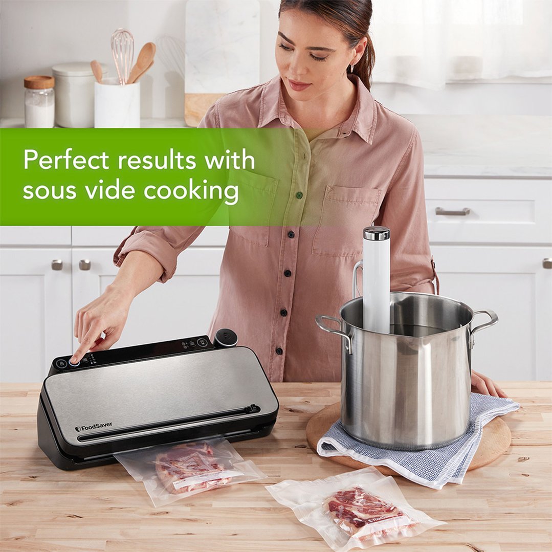 Woman using a FoodSaver food vacuum sealer with sous vide cooking setup
