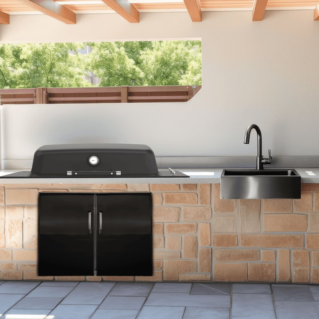 Black built-in barbeque and sink in an outdoor kitchen with brick base