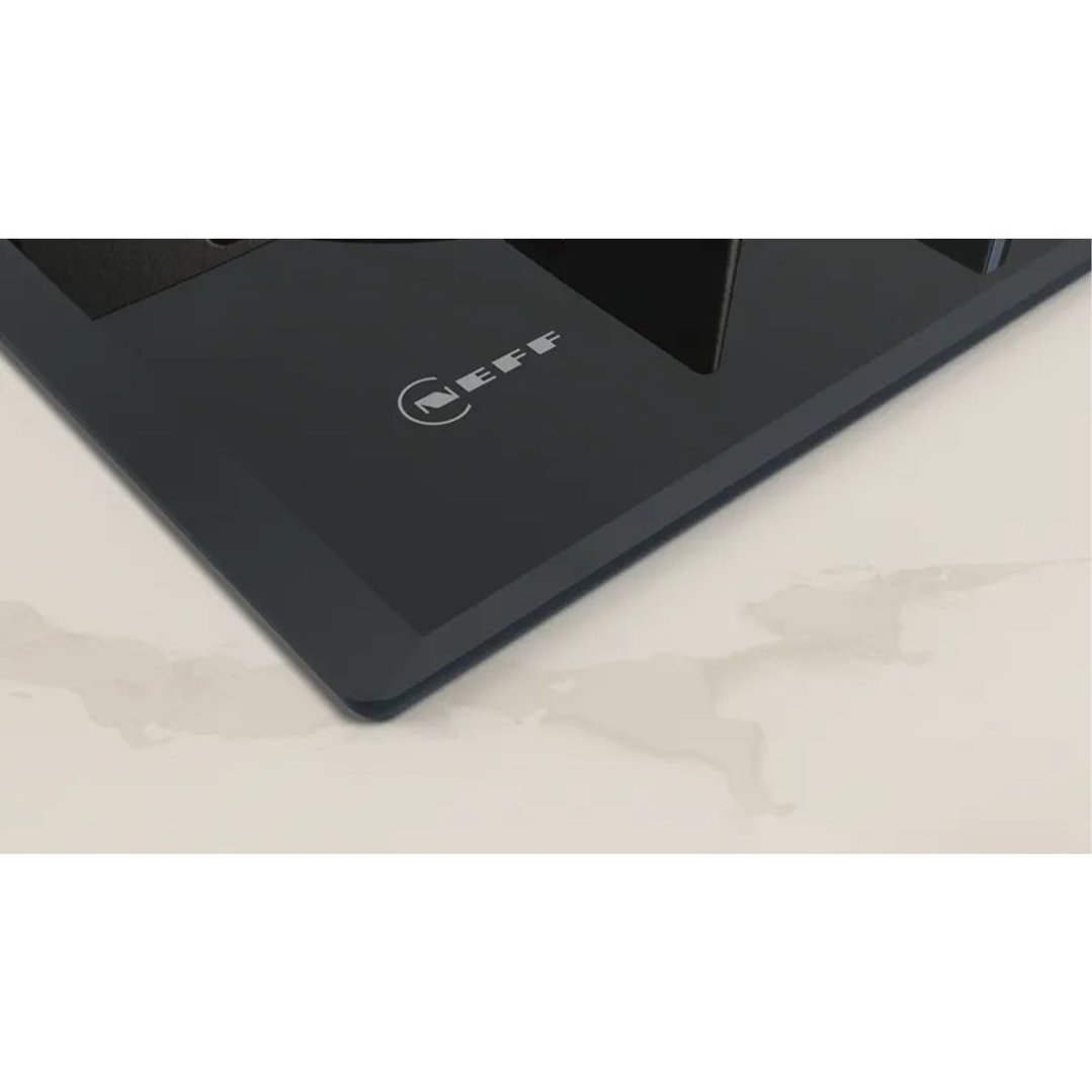 Close up of a black cooktop with the Neff logo on a light countertop