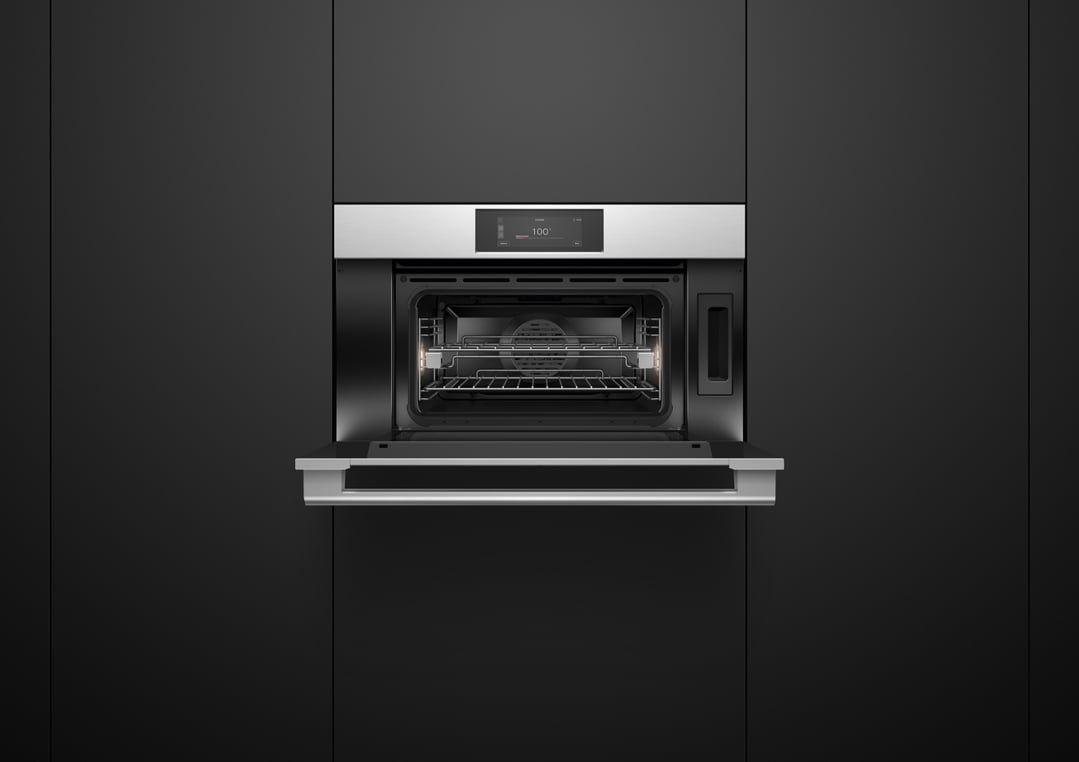 A built-in combi-steam oven with its door open, set into dark cabinetry