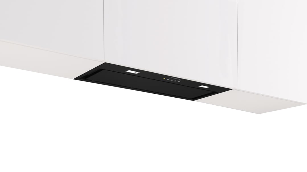 Black integrated Bosch rangehood with lights in a white kitchen cabinet