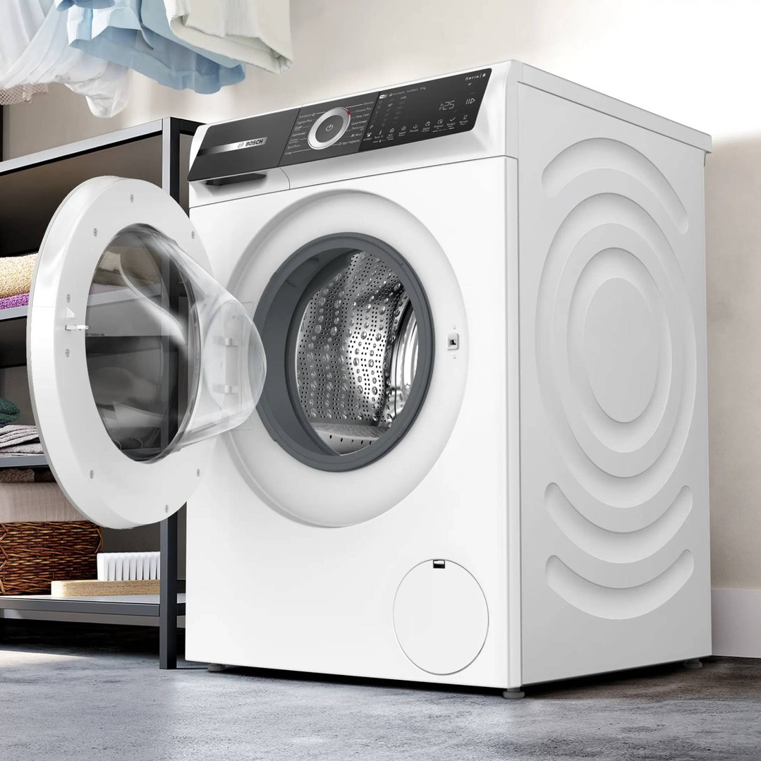 White Bosch Series 8 Front Loader Washing Machine with door open in a laundry setting