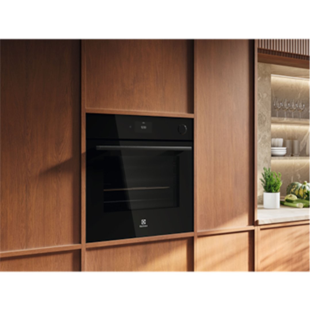 Black built-in Electrolux oven in a modern kitchen with wooden cabinetry