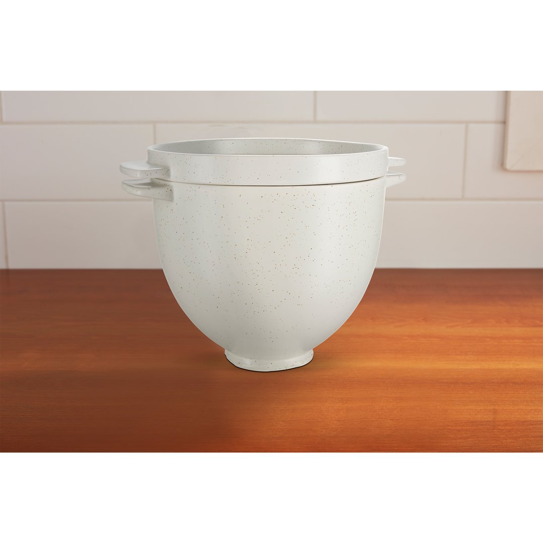 White KitchenAid Artisan Bread Bowl with speckles on a wooden countertop