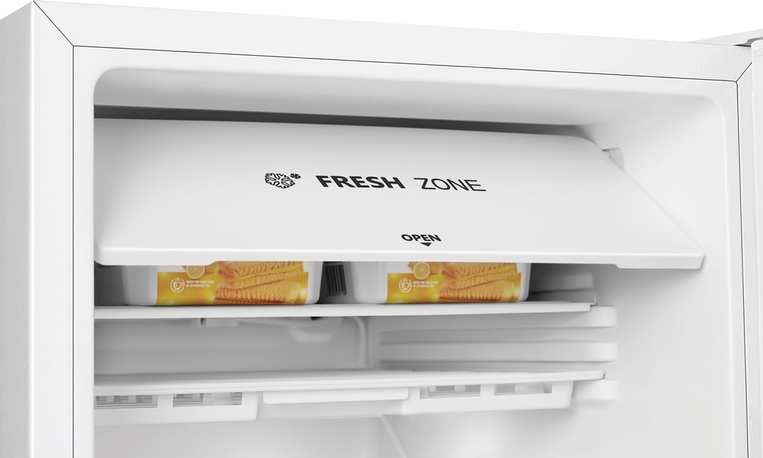 Inside a white bar fridge showing the fresh zone compartment with packaged food