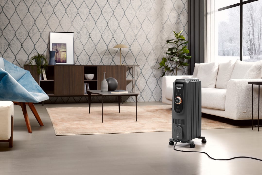 Dragon Connect oil column heater in a living room with a sofa