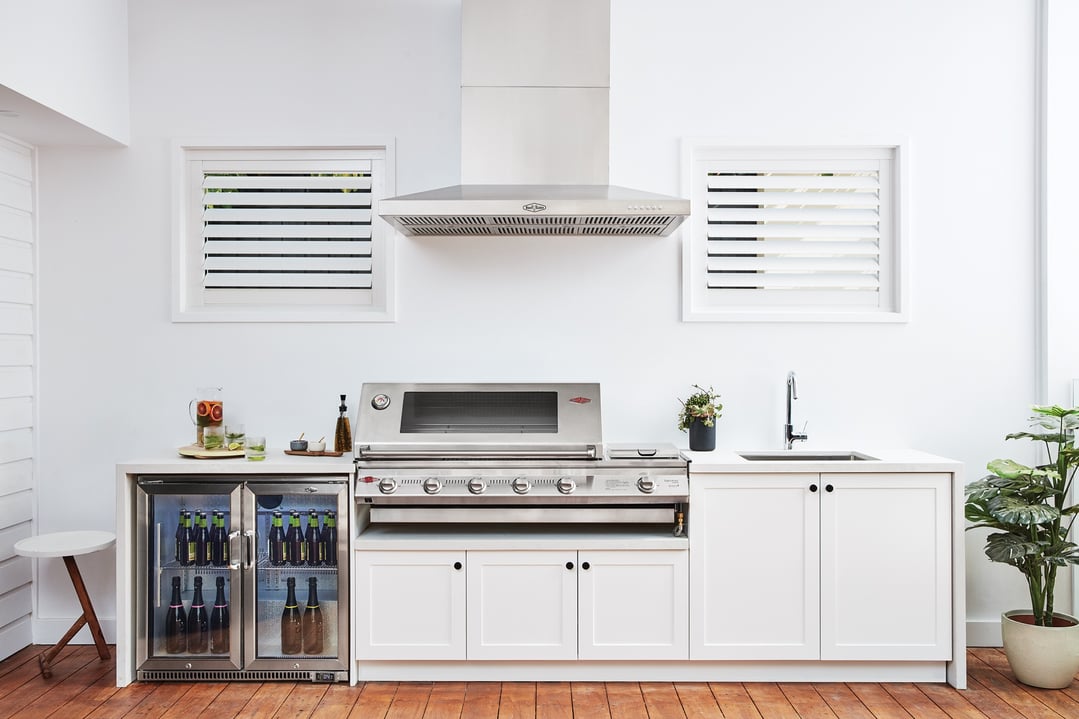 Outdoor kitchen with a BEEFEATER Signature ProLine Outdoor Canopy Hood over a grill