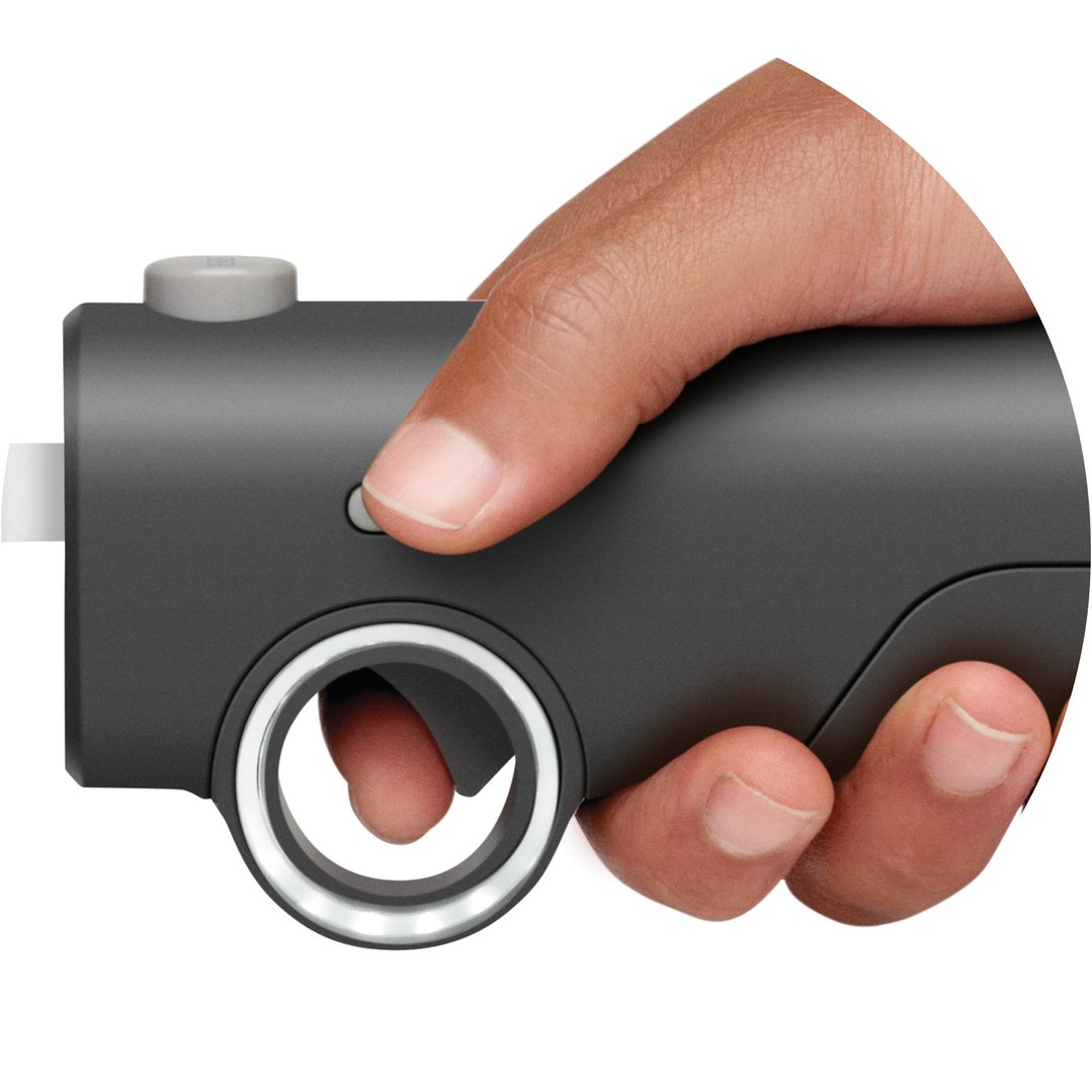 Hand holding the Breville Cordless Electric Knife, pressing a button