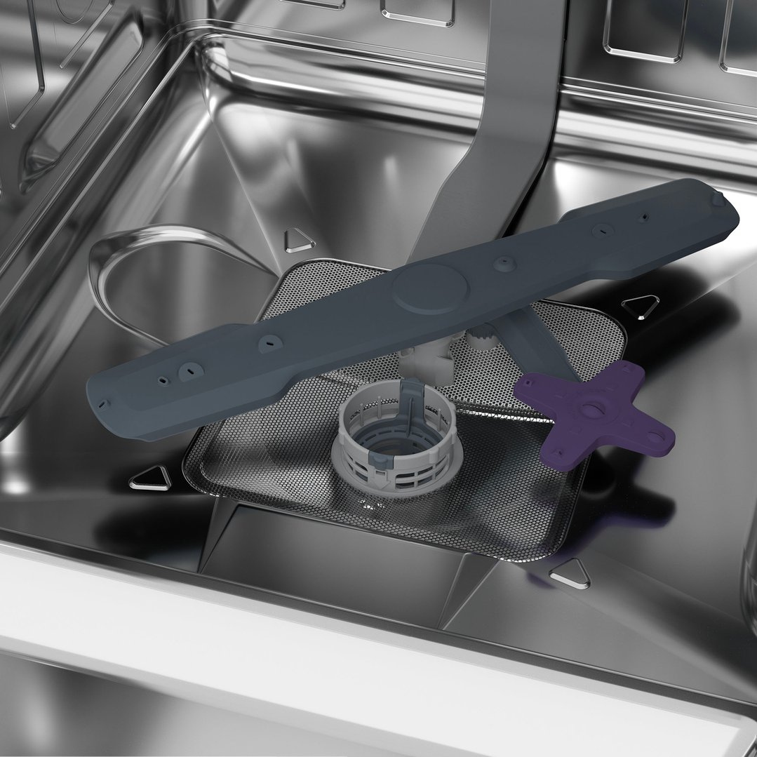 Close-up of the interior of a dishwasher, showing the filter and spray arm
