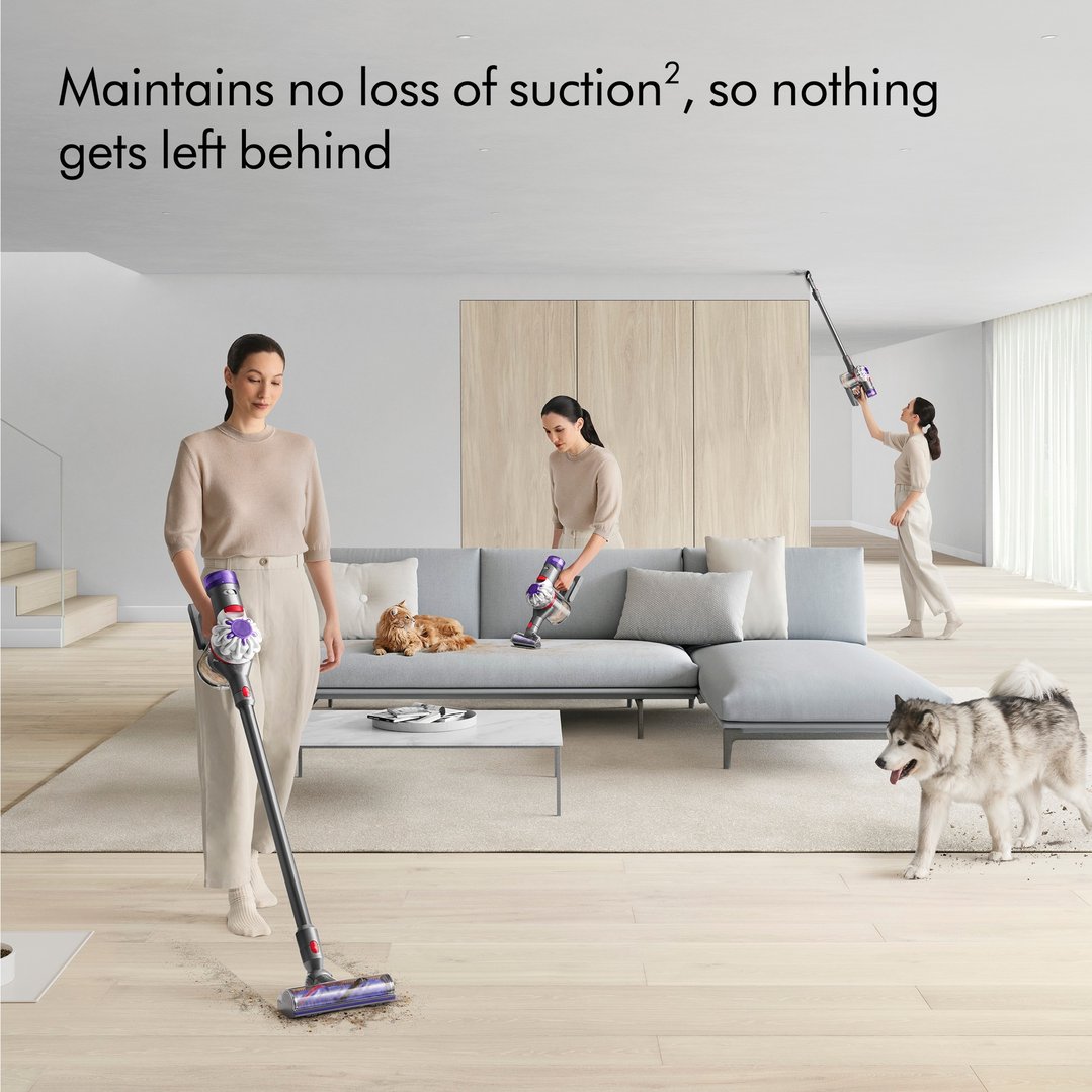 Three women using Dyson handStickVacuums to clean a living room with pets