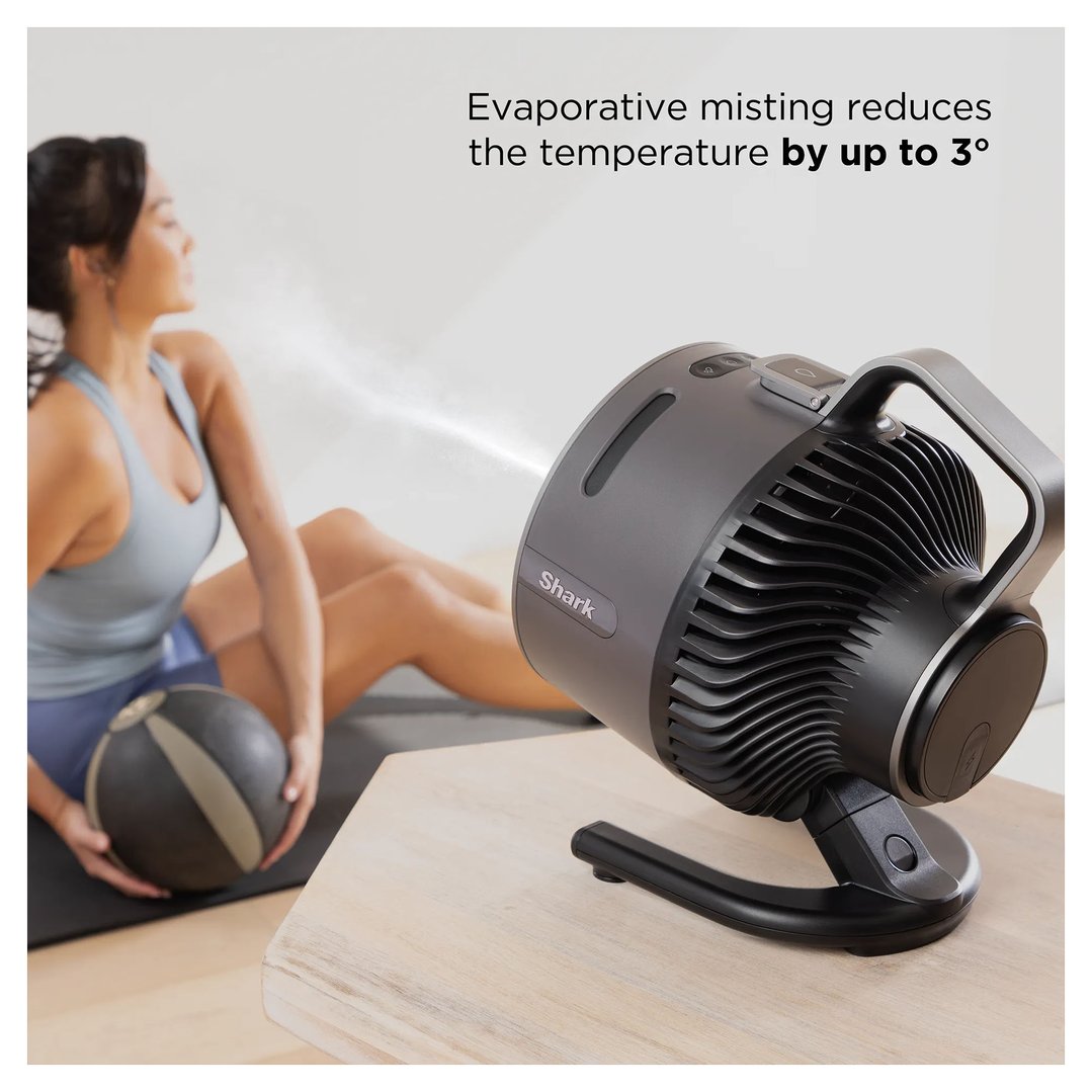 Shark FlexBreeze HydroGo misting portable fan on a table, misting a woman exercising