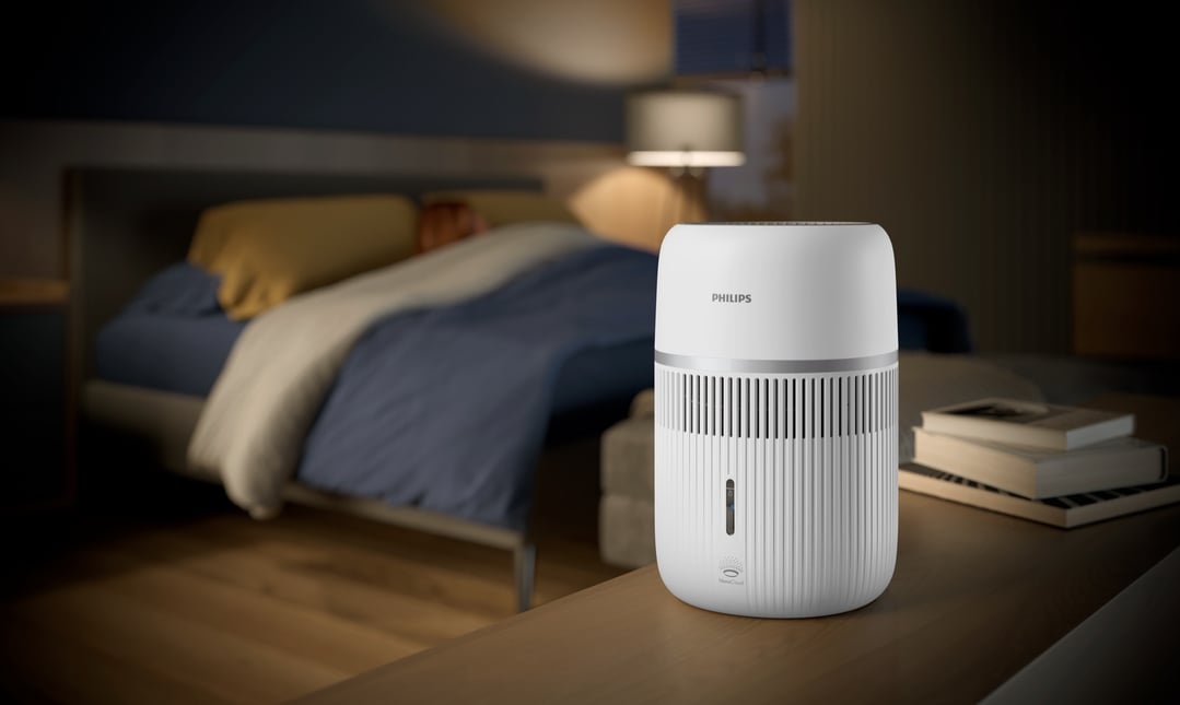 Philips Air Humidifier 4000 Series on a wooden table in a bedroom setting