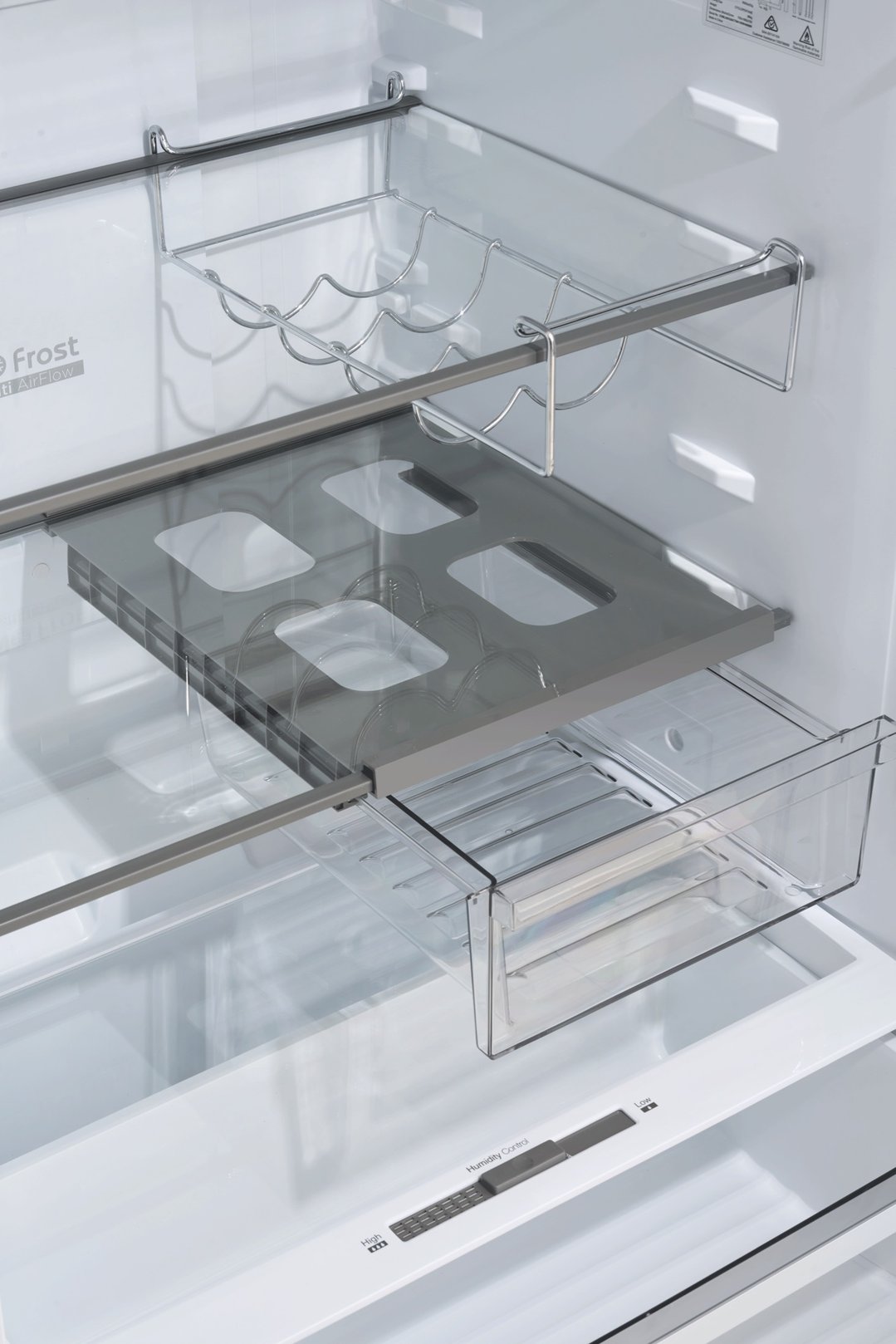 Interior view of a top mount fridge showing shelves and drawers
