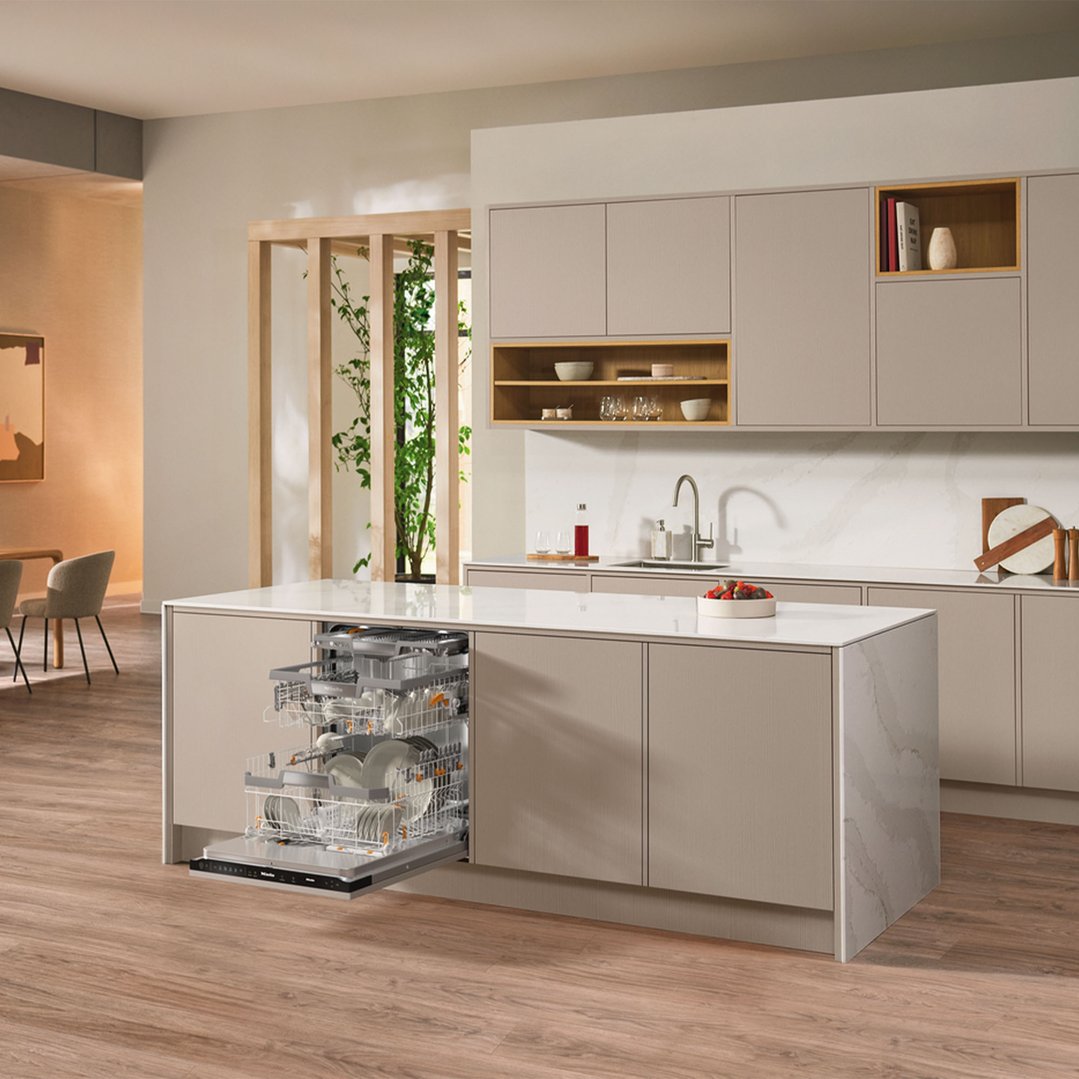 Integrated dishwasher with open door in a modern kitchen island setting
